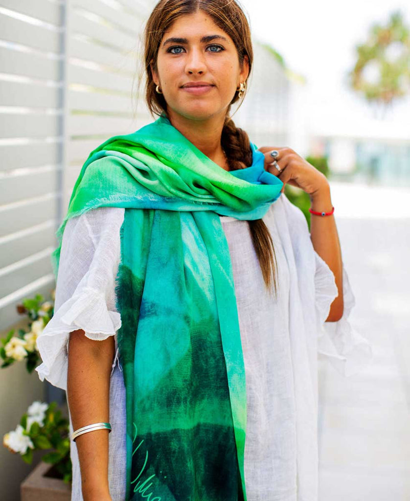 girl wearing printed green and blue scarf with original art design and artist signature